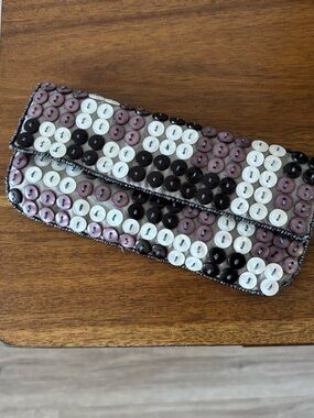 it’s button summer and this clutch says so